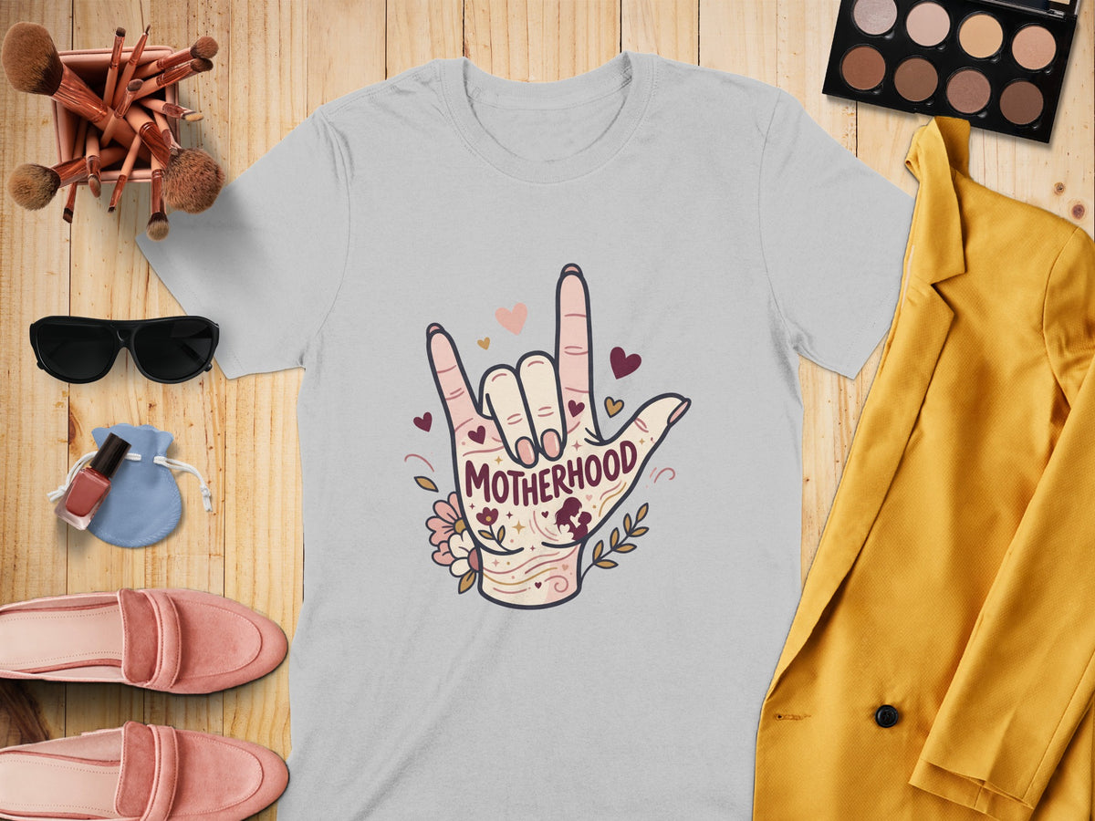 Grey t-shirt with "Motherhood" text in a hand gesture design.