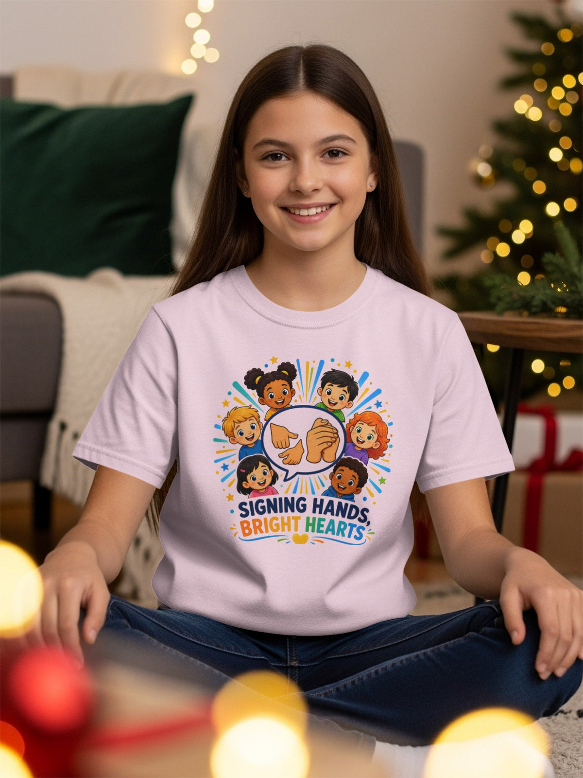 Children's shirt with diverse kids signing and "Signing Hands, Bright Hearts" text.