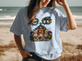 T-shirt with "Trick or Treat" text and Halloween graphic of dolls, pumpkins, and mushrooms.