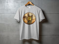White t-shirt with a circular graphic of a hand making rock horns, a cricket ball, and wavy patterns.