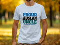 White t-shirt with "PROUD AUSLAN UNCLE" text in blue, black, and green.