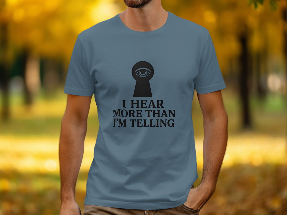 Teal t-shirt with black keyhole graphic containing an eye and text "I HEAR MORE THAN I'M TELLING".