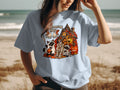 Halloween graphic with cats, skeleton, and haunted house, reads "Someone Say".
