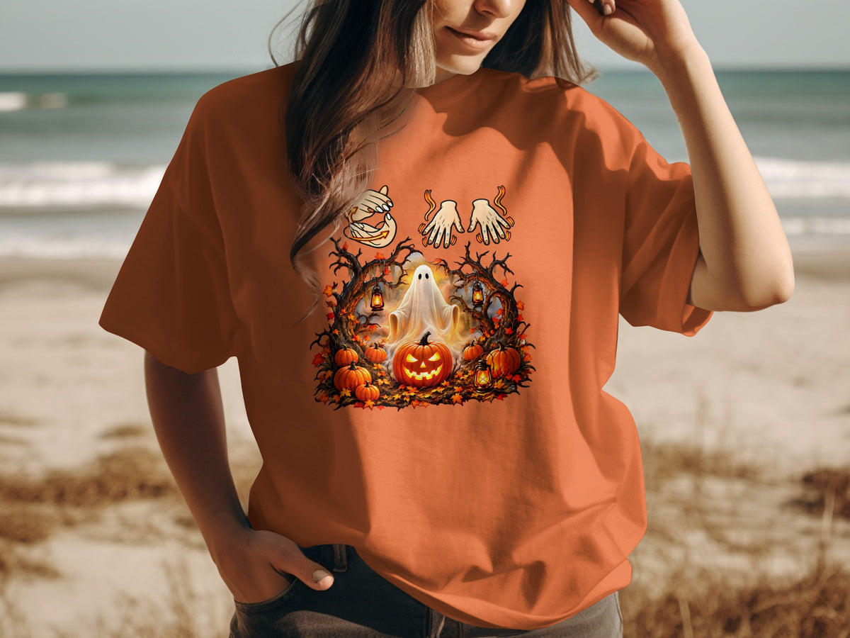Orange t-shirt with Halloween ghost, pumpkin, leaves, and lanterns graphic.