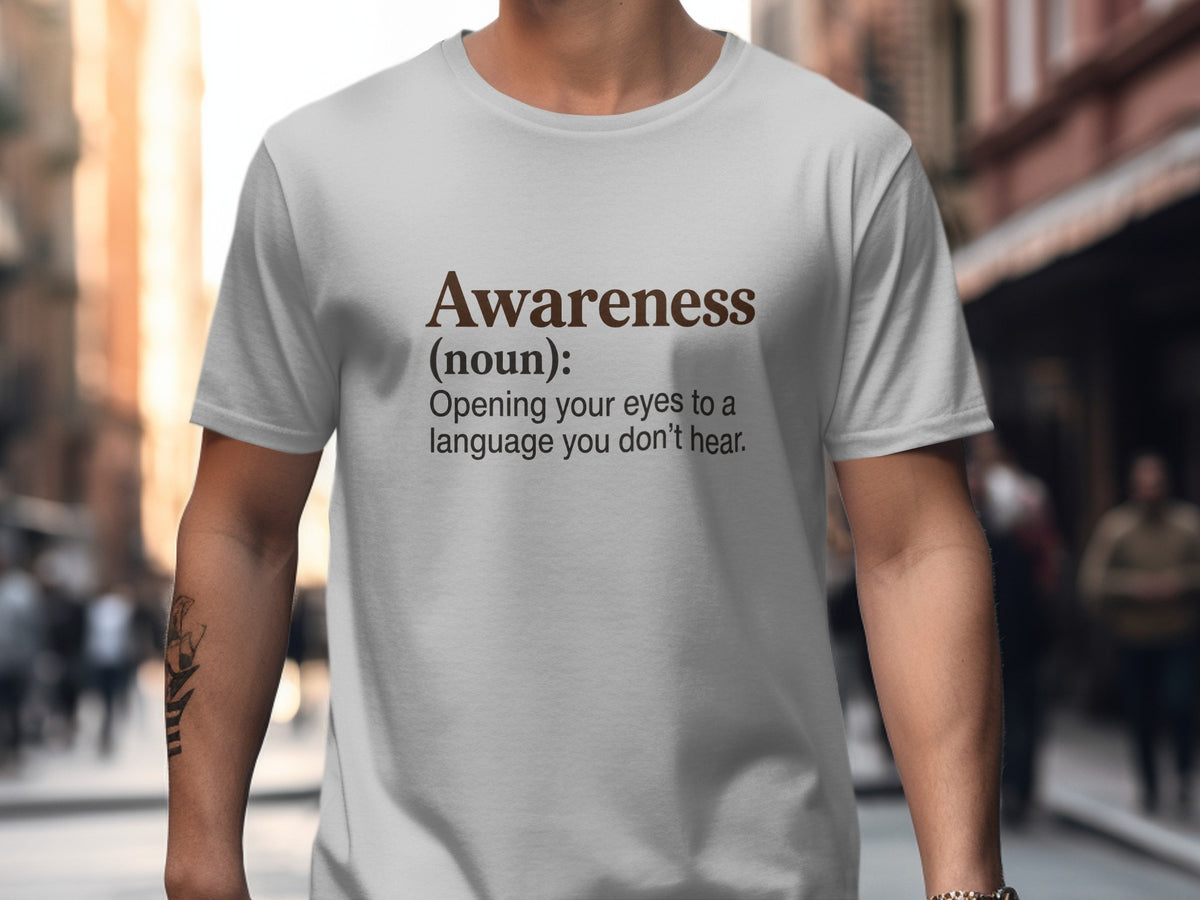 White t-shirt with "Awareness (noun): Opening your eyes to a language you don't hear." text.