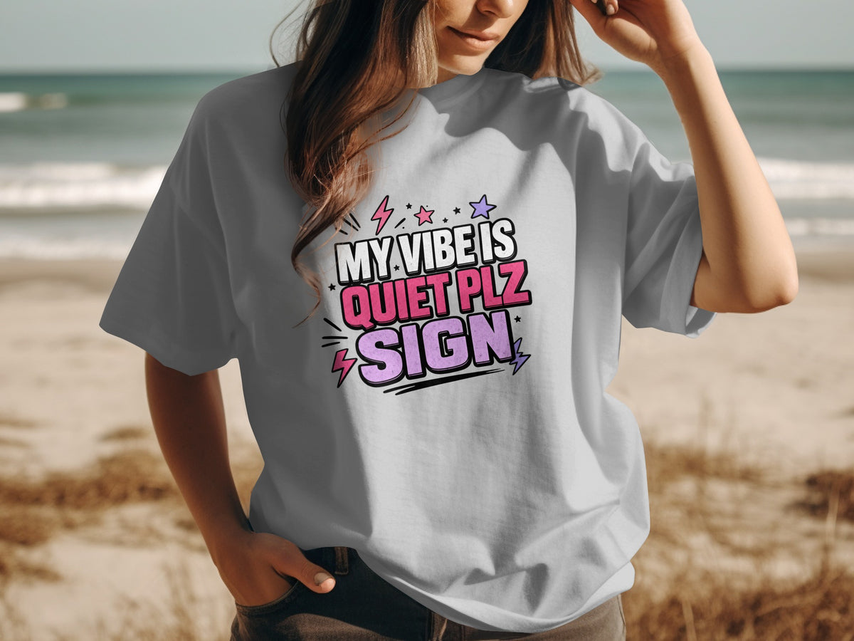 Grey t-shirt with pink and purple text saying "MY VIBE IS QUIET PLZ SIGN".
