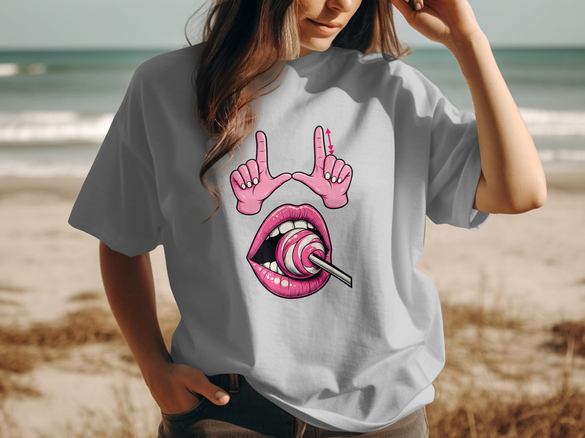 Grey t-shirt with pink cartoon graphic of lips and hands holding a lollipop.