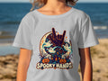 T-shirt with "Spooky Hands" Halloween design featuring ghosts, pumpkins, and a haunted house.