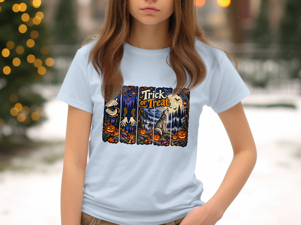 Light blue t-shirt with a Halloween graphic featuring "Trick or Treat" text, pumpkins, and a wolf.