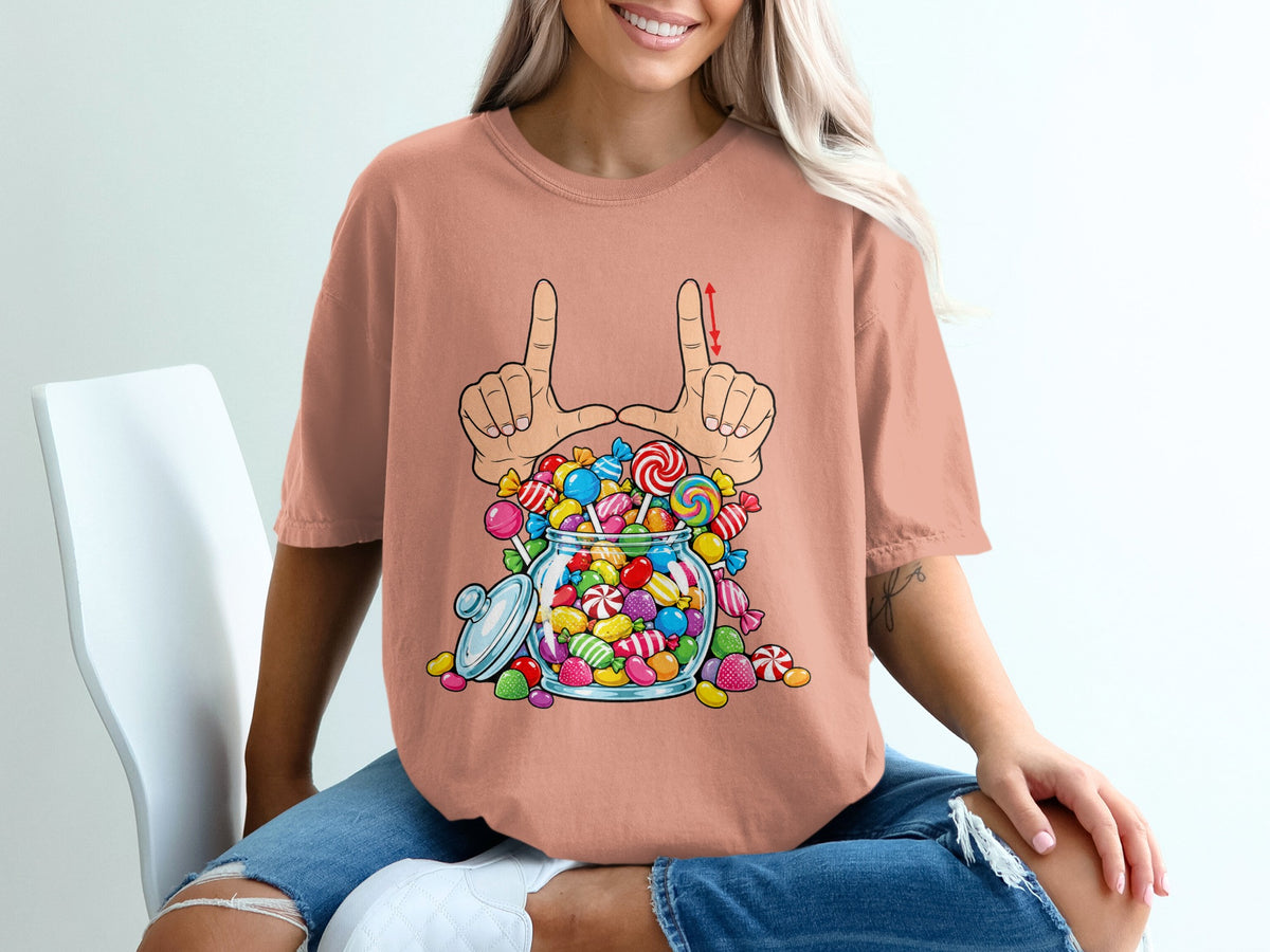 T-shirt graphic of hands framing a overflowing jar of colorful candies and lollipops.