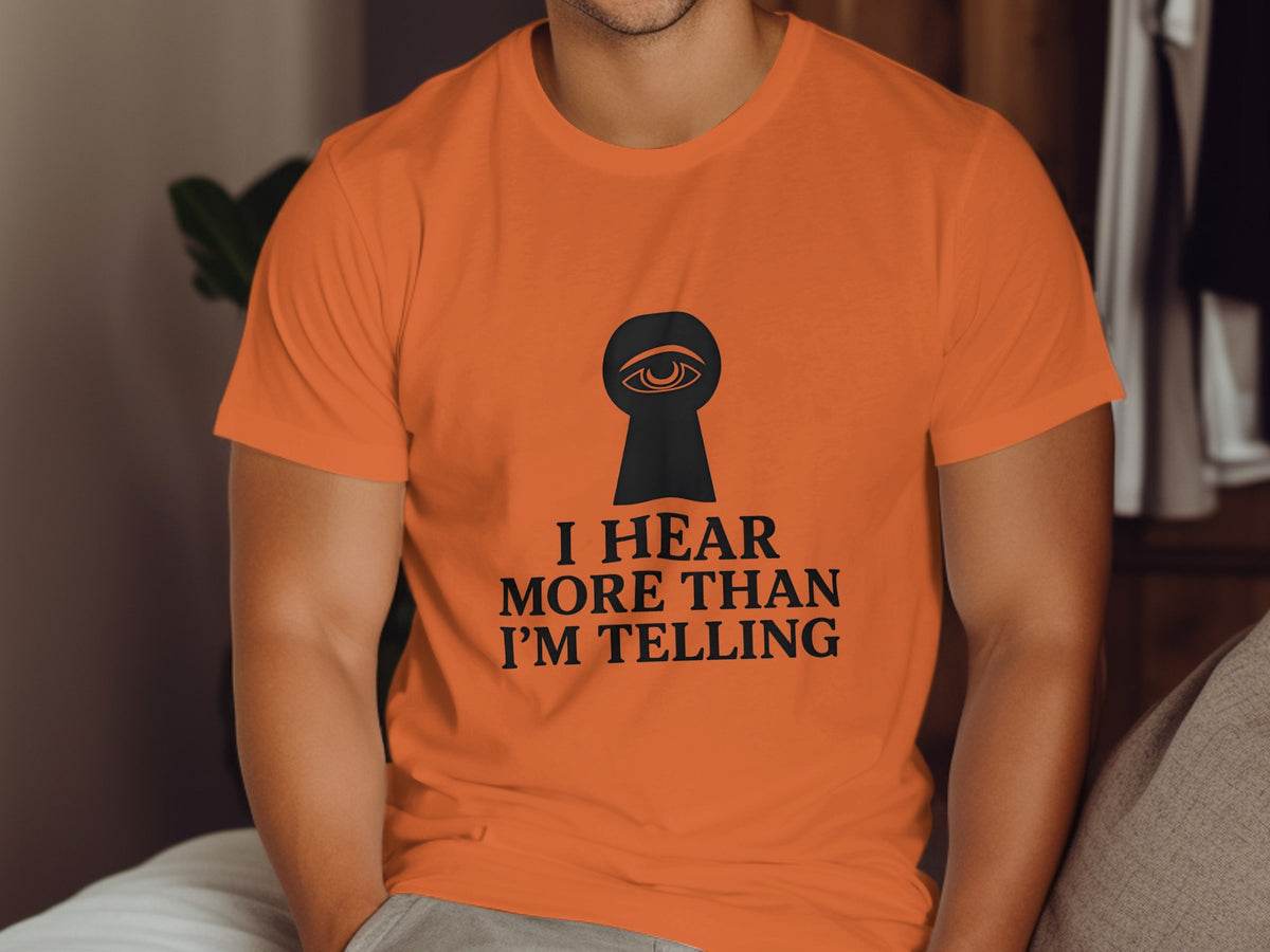 Orange t-shirt with black keyhole eye graphic and text.