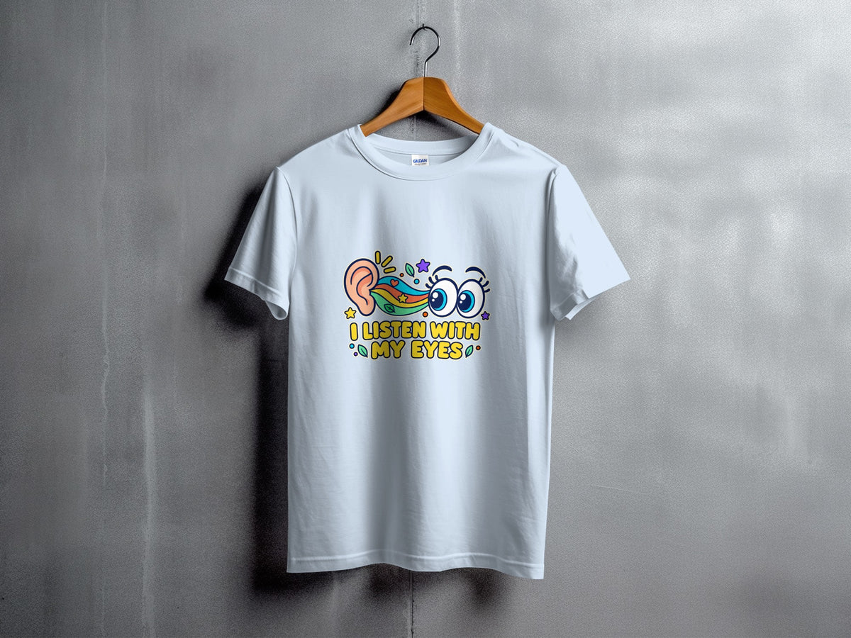 White t-shirt with "I LISTEN WITH MY EYES" text and cartoon eye and ear graphics.