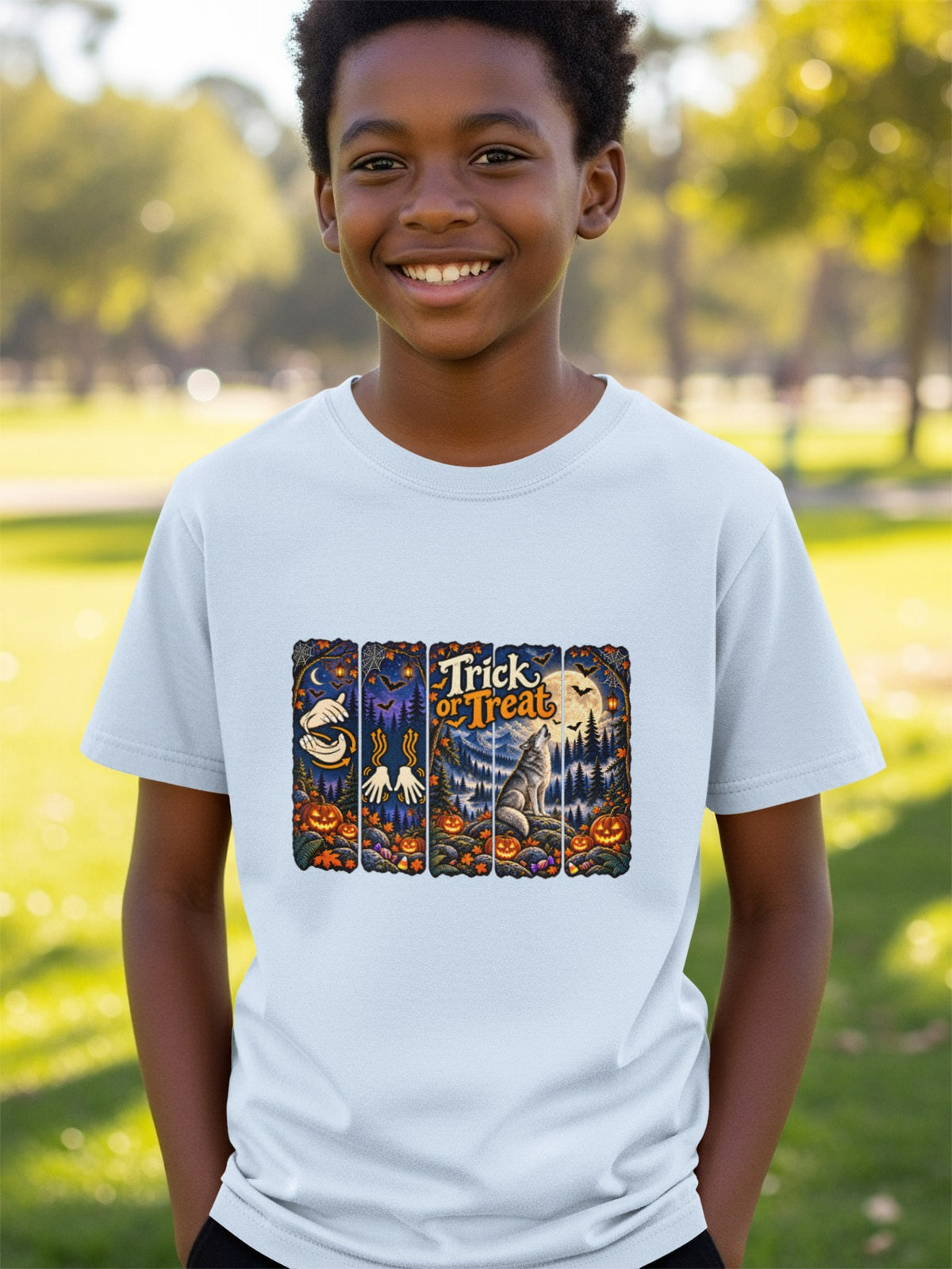 Boy in t-shirt with Halloween themed graphic featuring pumpkins, bats, a wolf, and "Trick or Treat" text.