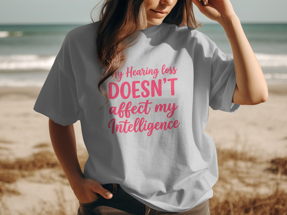 Gray t-shirt with pink text that says "My Hearing loss DOESN'T affect my Intelligence".