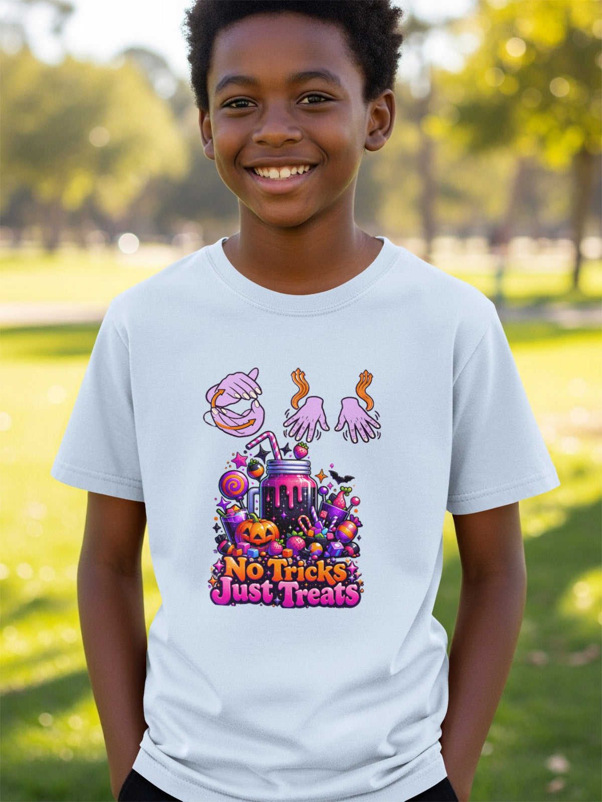 Kids light blue t-shirt with "No Tricks Just Treats" Halloween graphic.
