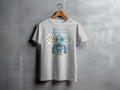 Light gray t-shirt with a colorful cartoon robot and text "VISUAL VOICE BRIGHT SIGNAL".