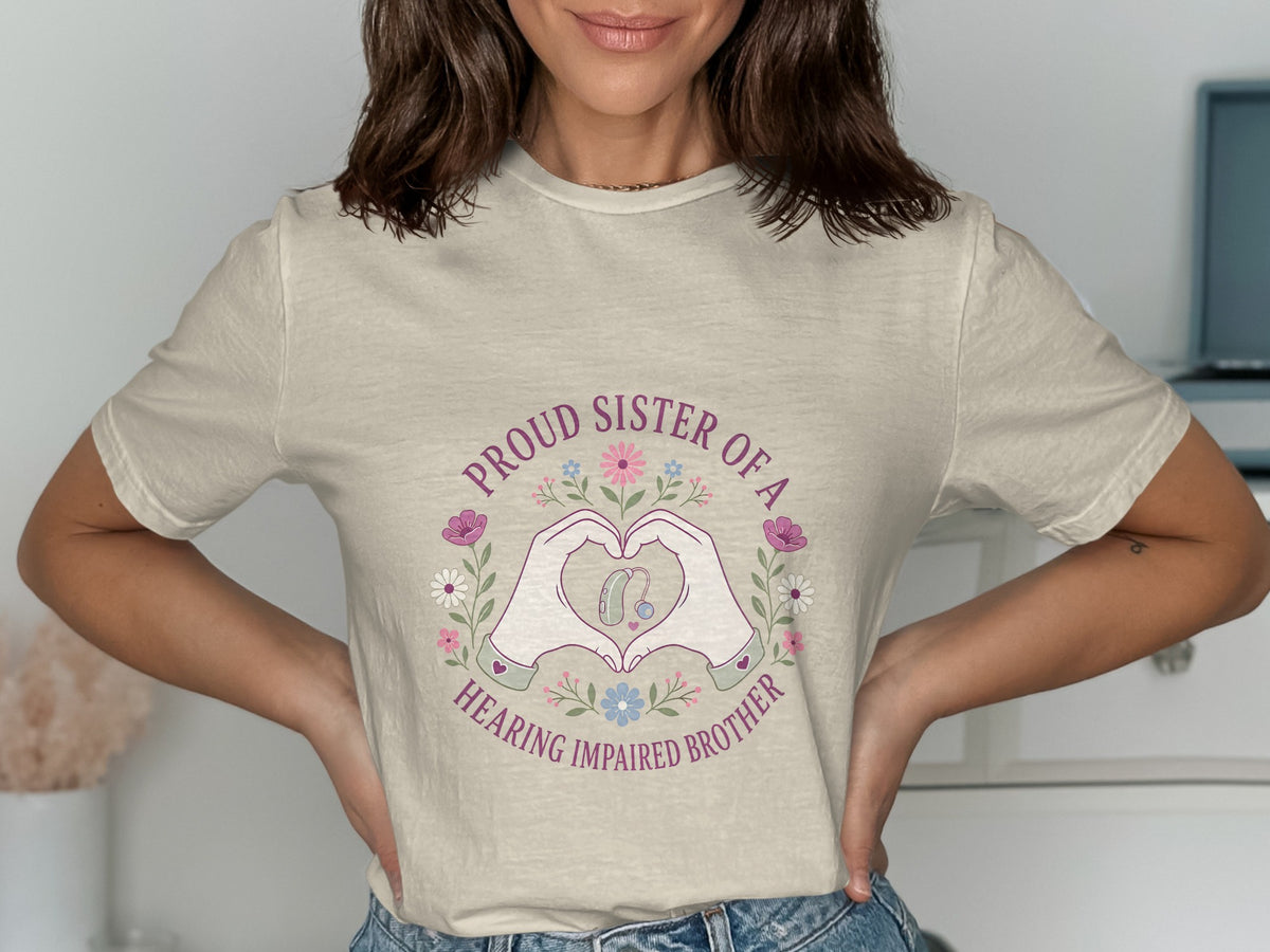 Proud sister of a hearing impaired brother t-shirt with heart hands and hearing aid graphic.