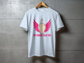 Light blue t-shirt with pink wings and middle finger graphic and text "MY HANDS TALK TOO".