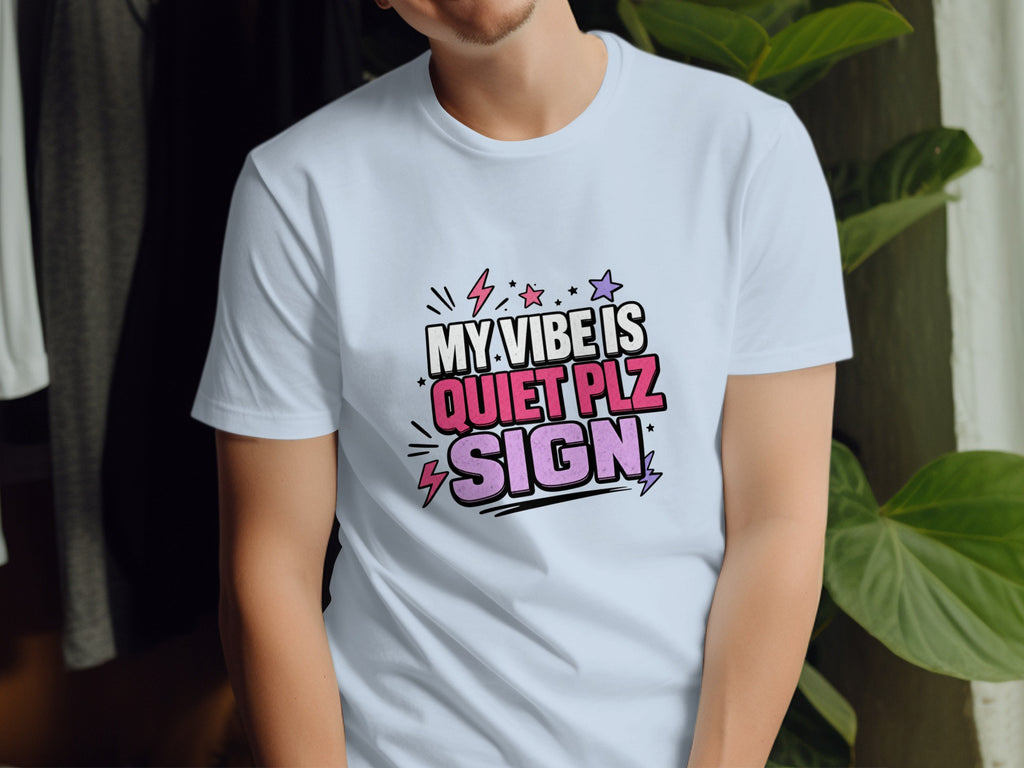 Light blue t-shirt with "MY VIBE IS QUIET PLZ SIGN" graphic and lightning bolts.