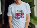 Light blue t-shirt with "MY VIBE IS QUIET PLZ SIGN" graphic and lightning bolts.