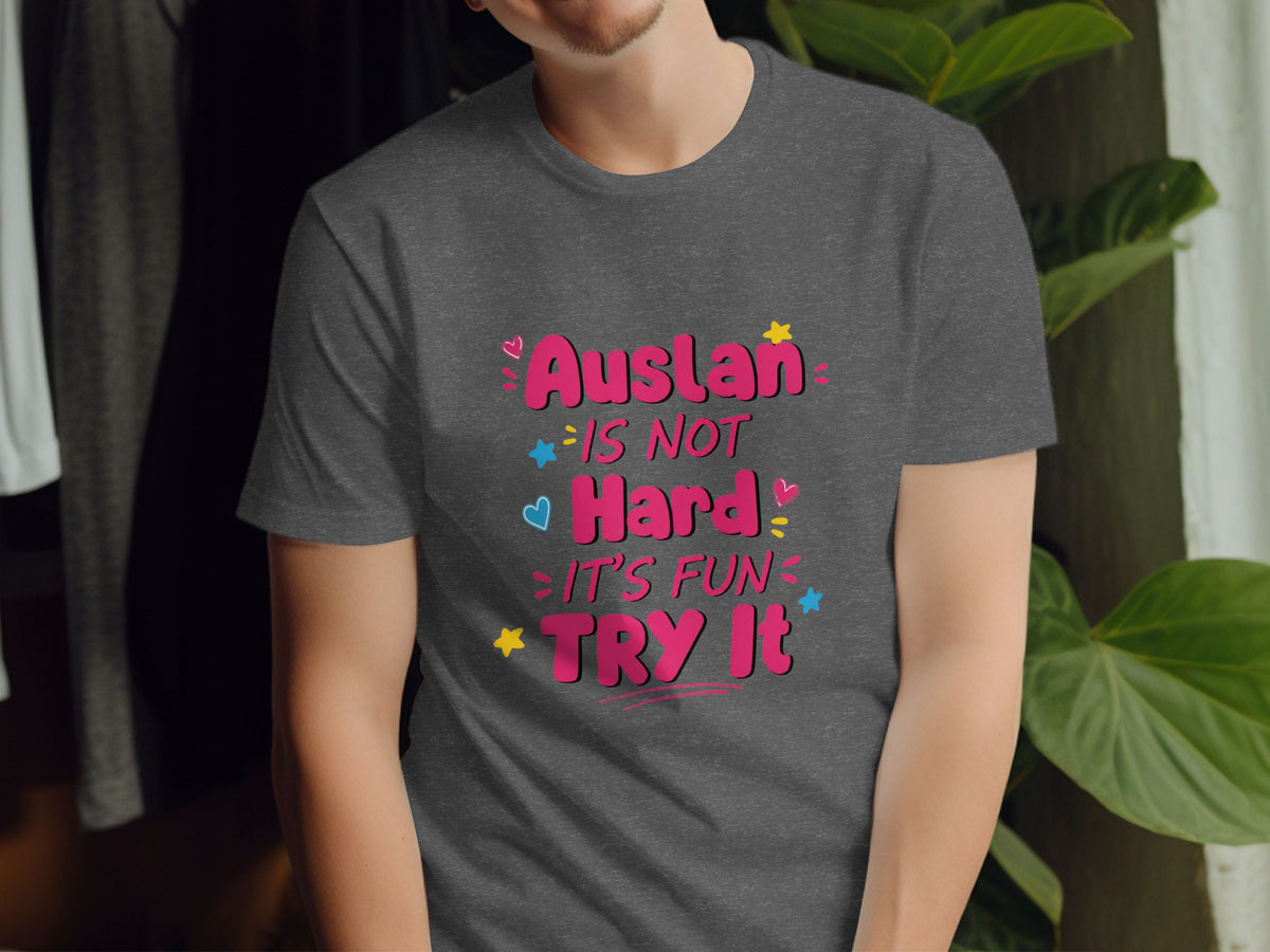 Dark gray t-shirt with pink text: Auslan is Not Hard, It's Fun, Try It.