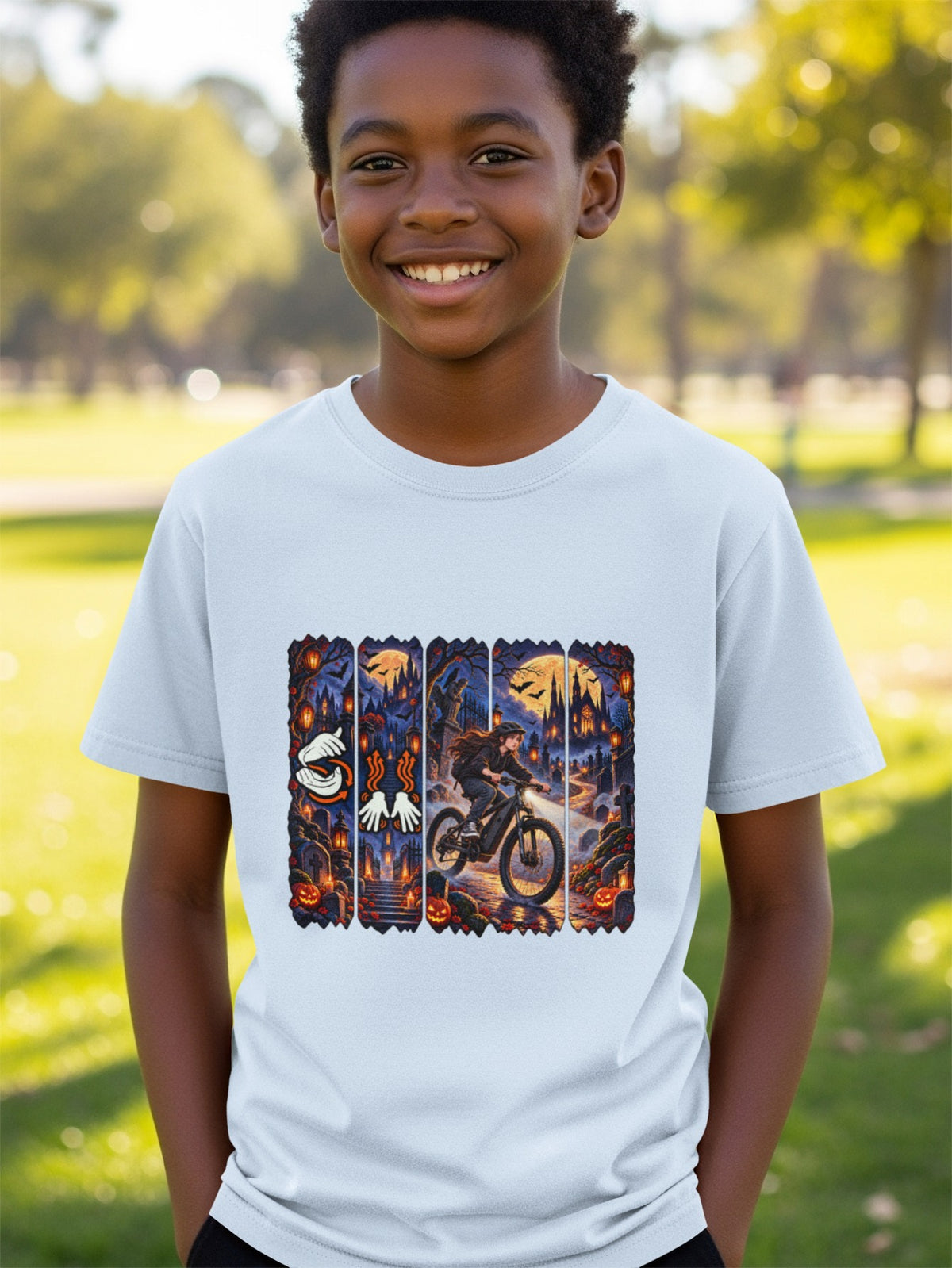 Boy wearing light blue t-shirt with Halloween graphic featuring girl on bicycle.