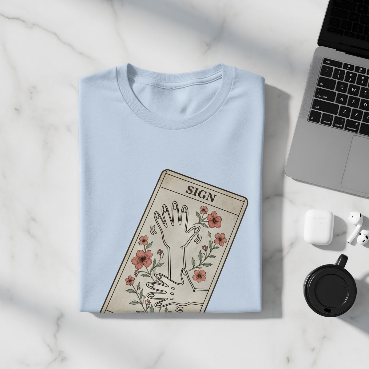 Light blue t-shirt with a graphic of hands and flowers, labeled "SIGN."
