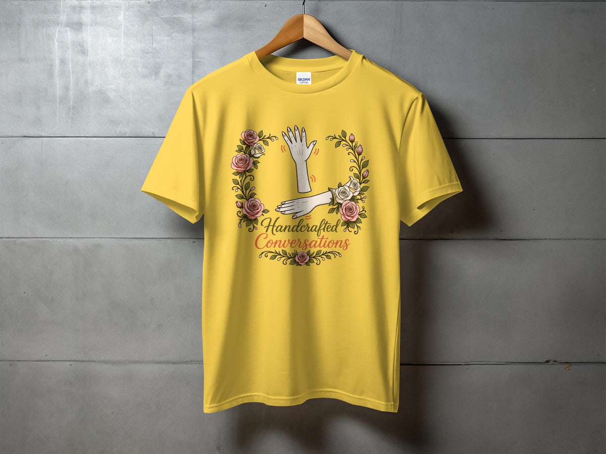 Yellow t-shirt with floral wreath and text "Handcrafted Conversations".