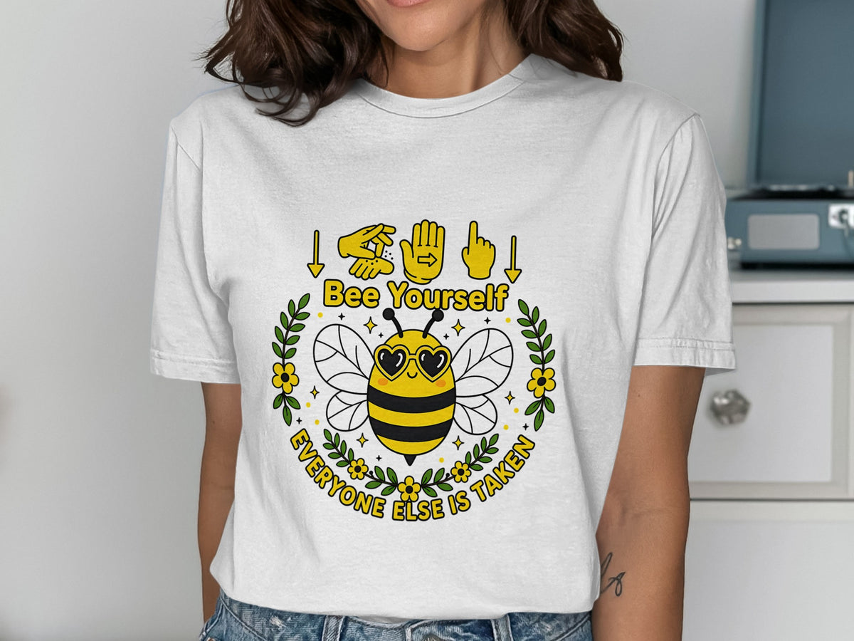 White t-shirt with a bee graphic and text "Bee Yourself Everyone Else Is Taken".