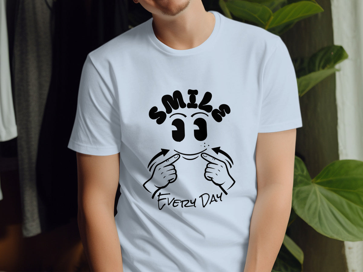 White t-shirt with black graphic design of "SMILE EVERY DAY" text and cartoon face.