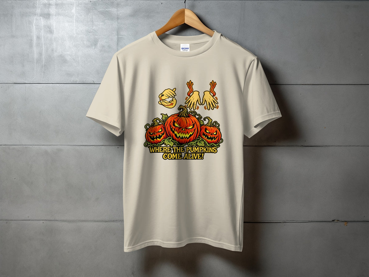 Light tan t-shirt with graphic of three jack-o'-lanterns and text "WHERE THE PUMPKINS COME ALIVE!".