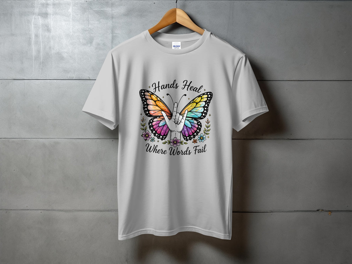 White t-shirt with butterfly and text "Hands Heal Where Words Fail".