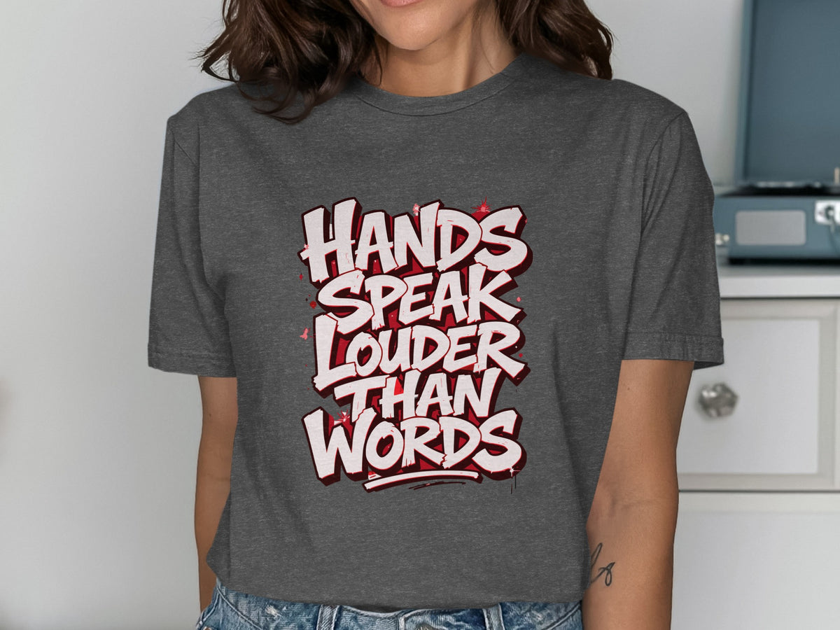 Dark gray t-shirt with white and red text "HANDS SPEAK LOUDER THAN WORDS" in graffiti style.