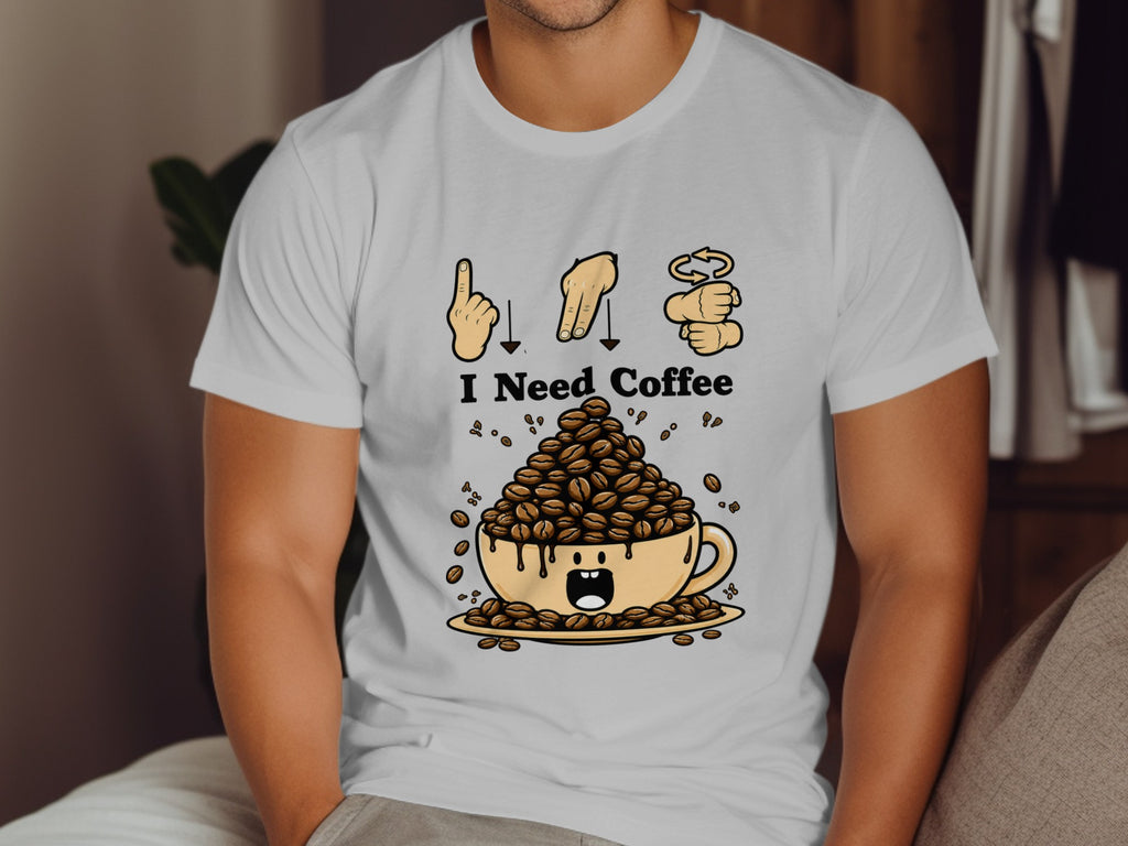 White t-shirt graphic with "I Need Coffee" and a cup overflowing with coffee beans.
