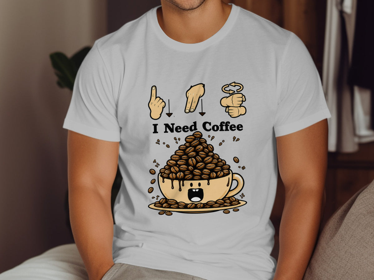 White t-shirt graphic with "I Need Coffee" and a cup overflowing with coffee beans.