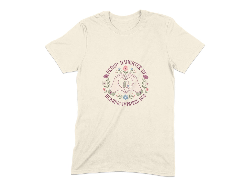Cream t-shirt with a heart shape formed by hands, enclosing a hearing aid and flowers. Text reads "Proud Daughter of Hearing Impaired Dad".