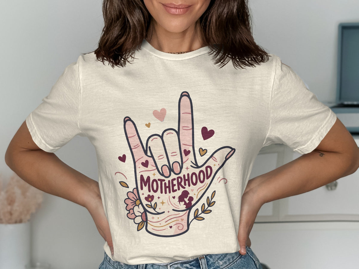 T-shirt with hand sign spelling "Motherhood" with hearts and flowers.