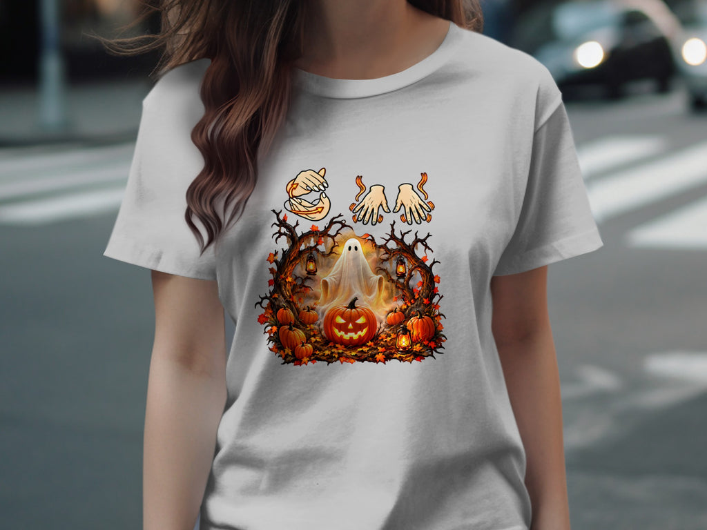 Halloween graphic on a t-shirt with ghost, pumpkins, and autumn leaves.