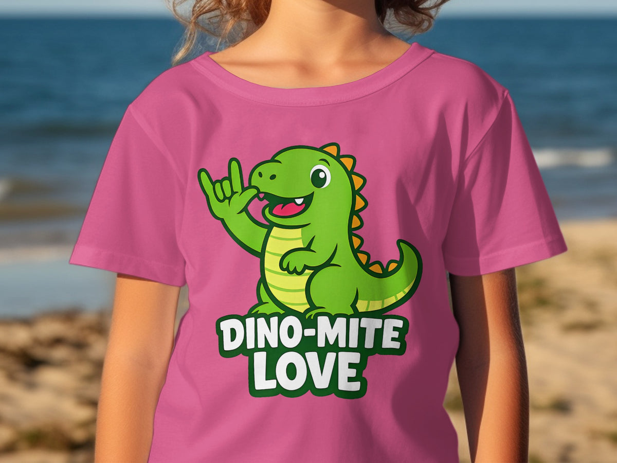 Pink t-shirt with a green dinosaur and the text "DINO-MITE LOVE".