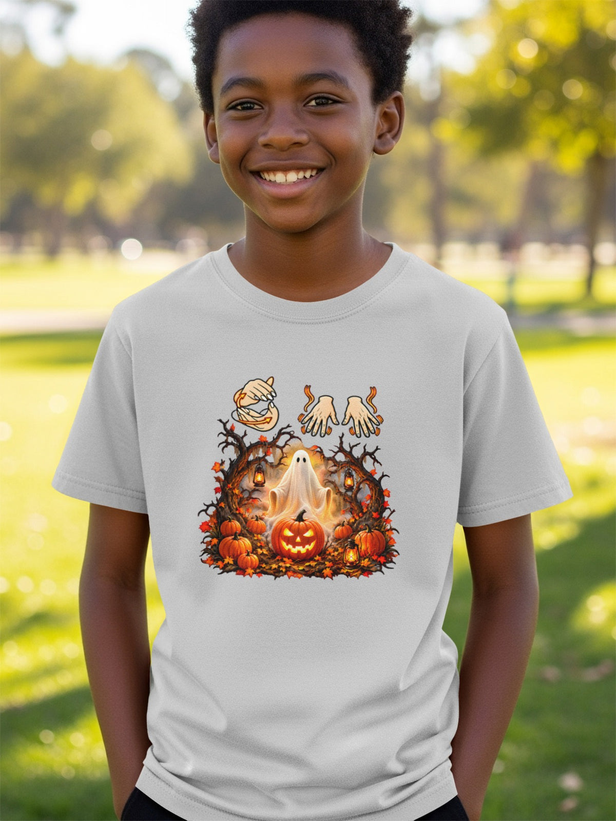 T-shirt with a Halloween graphic of a ghost, pumpkins, and spooky trees.