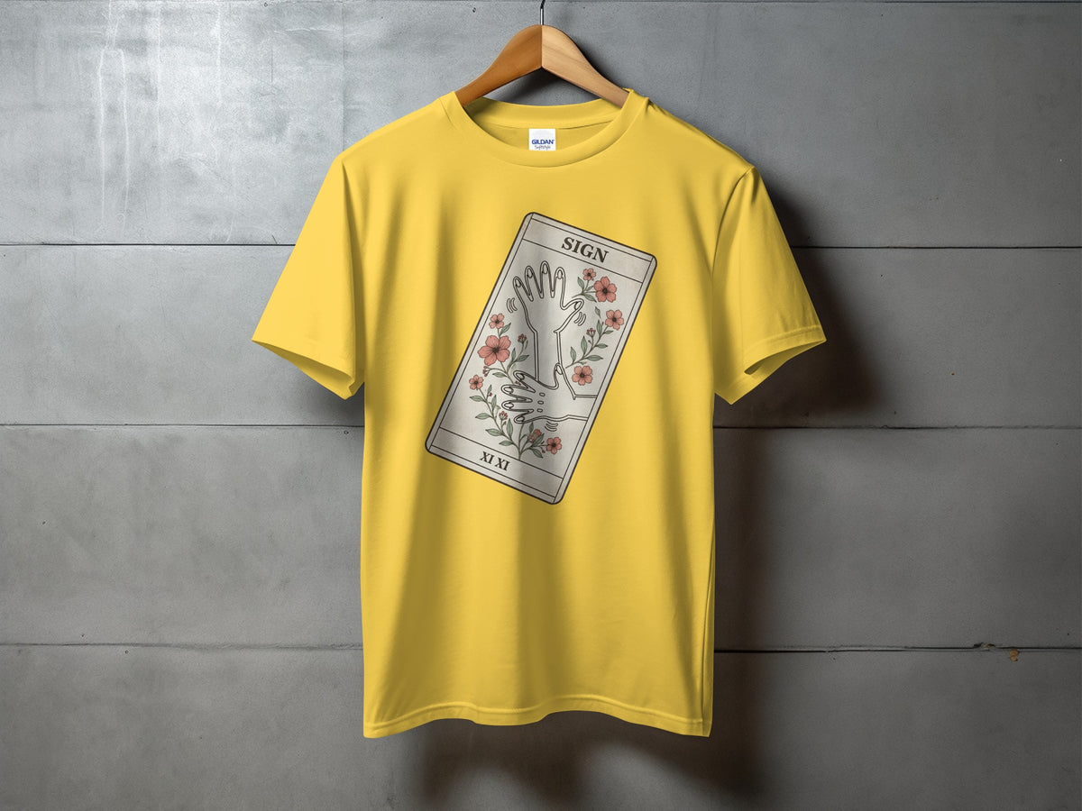 Yellow t-shirt with a tarot card graphic featuring hands and flowers.