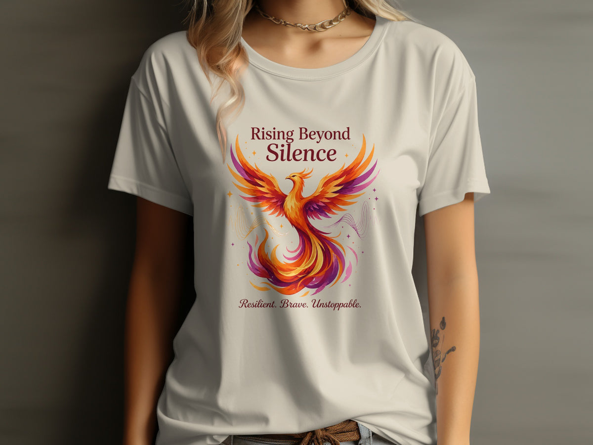 T-shirt with phoenix graphic and text "Rising Beyond Silence. Resilient. Brave. Unstoppable."