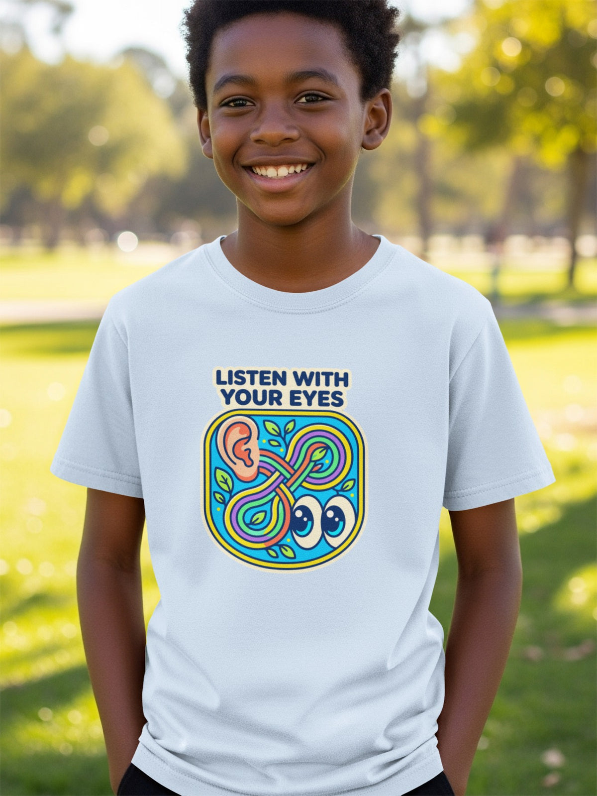 Light blue t-shirt with "Listen with Your Eyes" text and colorful ear and eyes graphic.