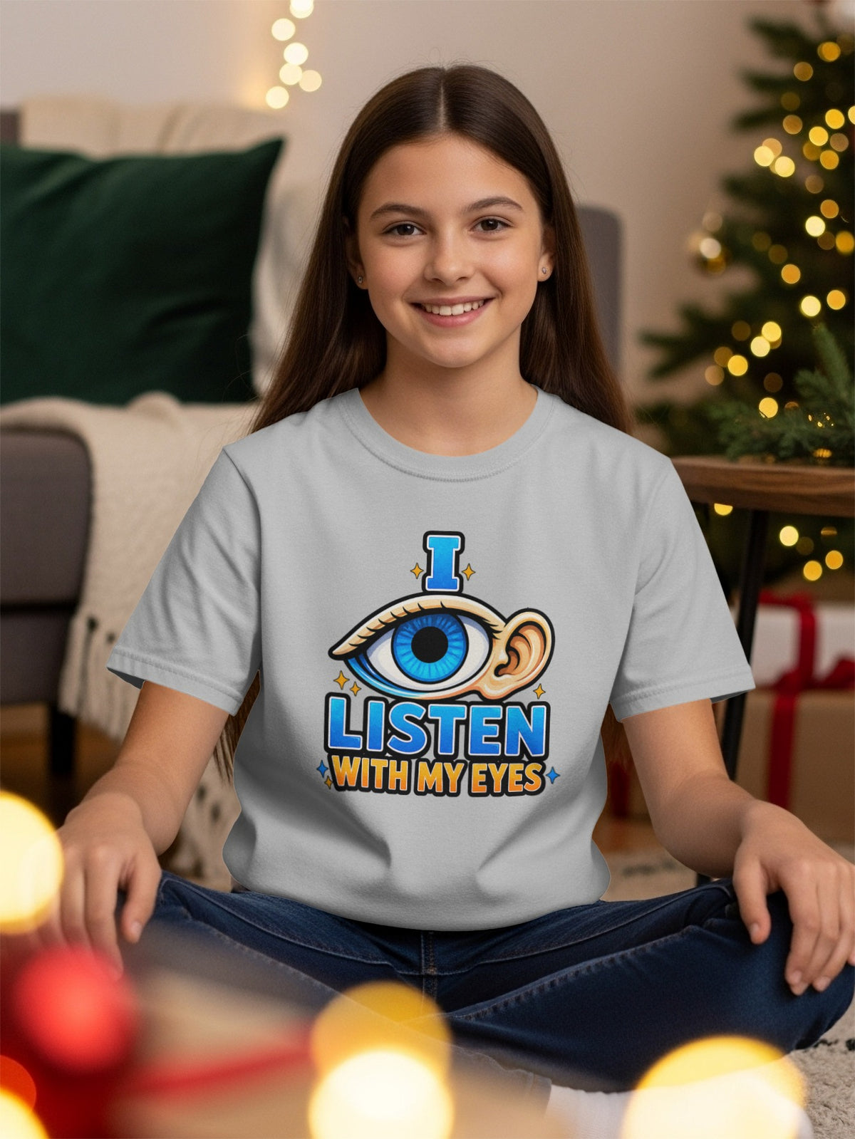 Grey t-shirt with graphic of an eye and ear, reading "I LISTEN WITH MY EYES".