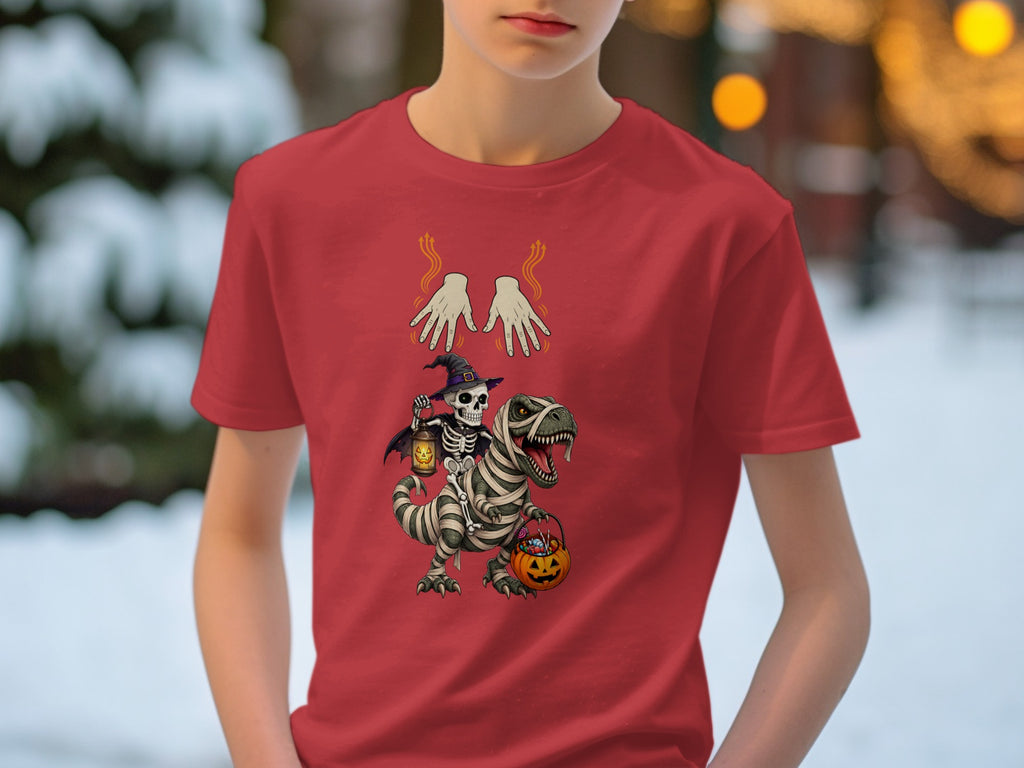 Skeleton riding a mummy dinosaur, holding a lantern and candy bucket, on red shirt.