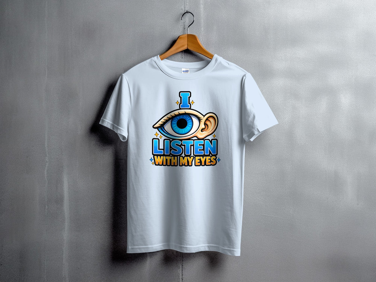 White t-shirt with "I LISTEN WITH MY EYES" text and eye and ear graphic.