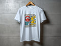 Light blue t-shirt with text "DON'T YELL, JUST USE GESTURES" and graphics.