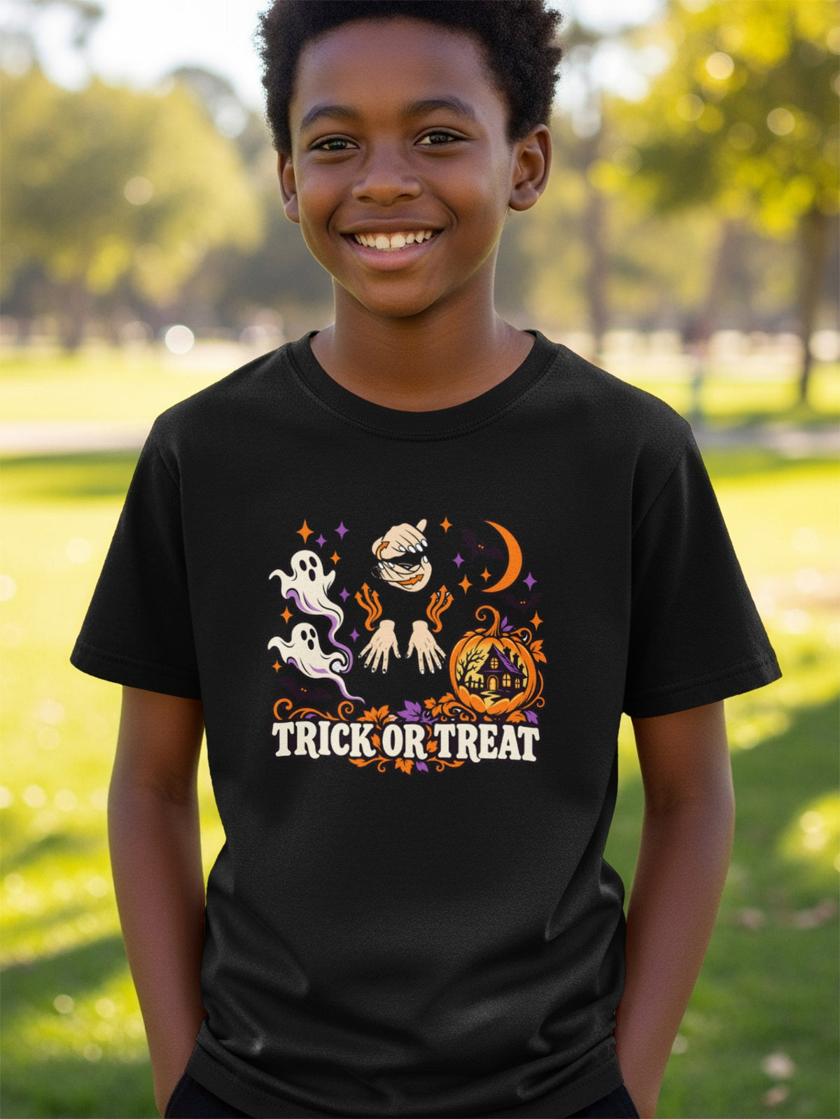 Black t-shirt with "Trick or Treat" Halloween graphic featuring ghosts and pumpkin house.