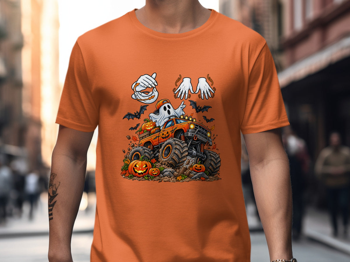 Orange t-shirt with a cartoon ghost driving a monster truck surrounded by pumpkins and bats.