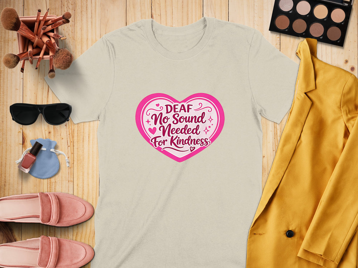 Light beige t-shirt with pink heart graphic that says "Deaf No Sound Needed For Kindness."